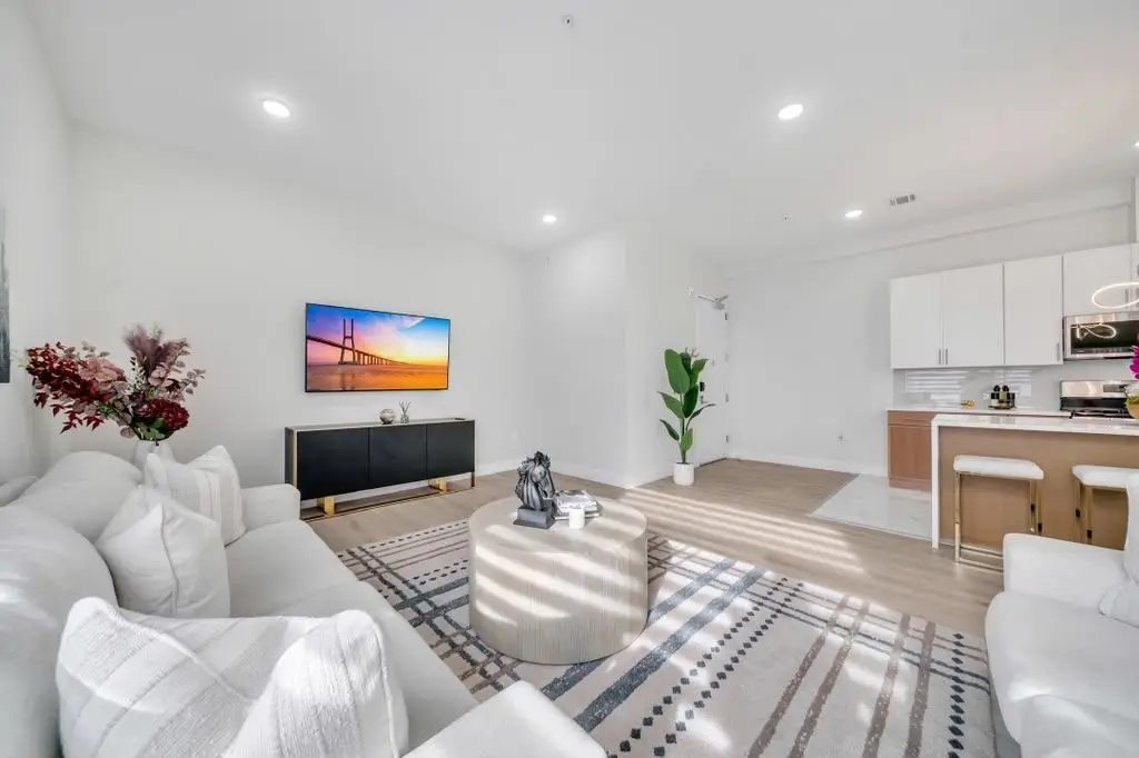 Living room with sofa, TV and open kitchen, Residence 402
