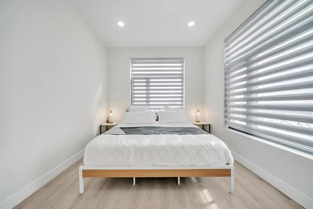 Bedroom with bed and window blinds, Residence 402