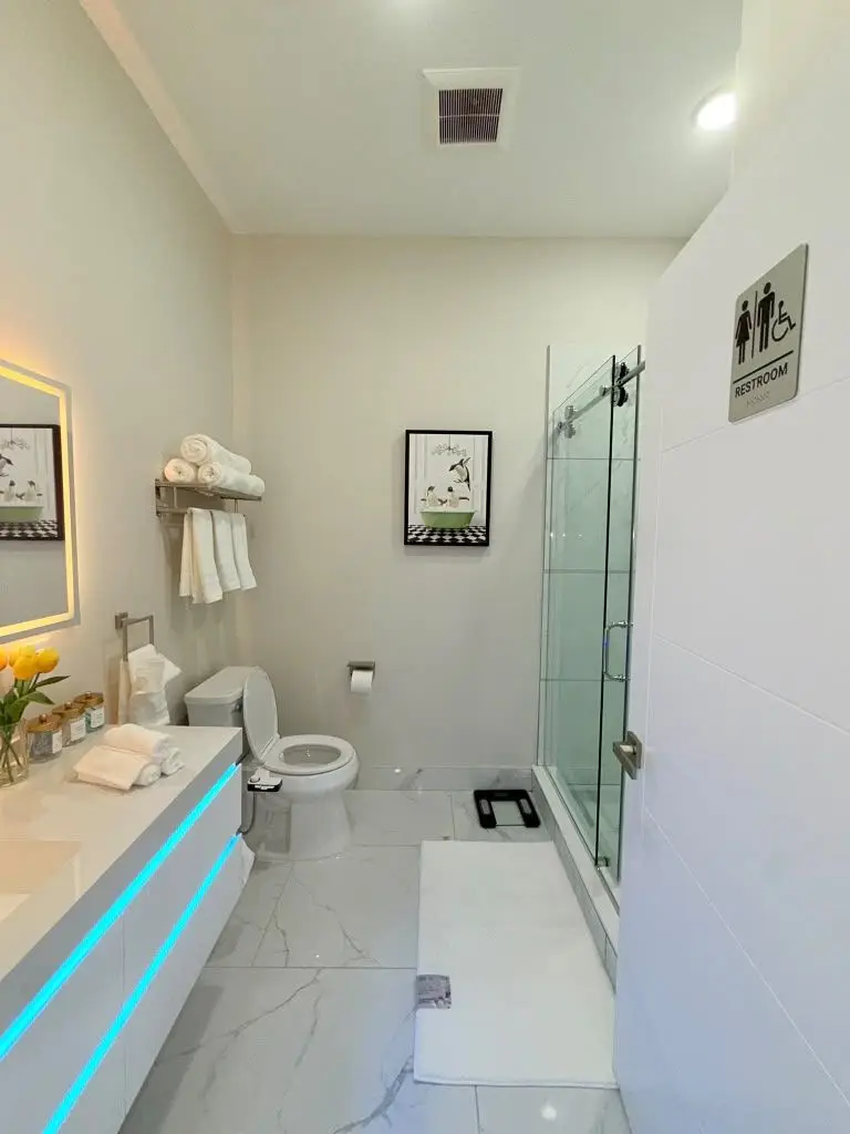 Bathroom with floating vanity, towels and glass shower, Residence 409