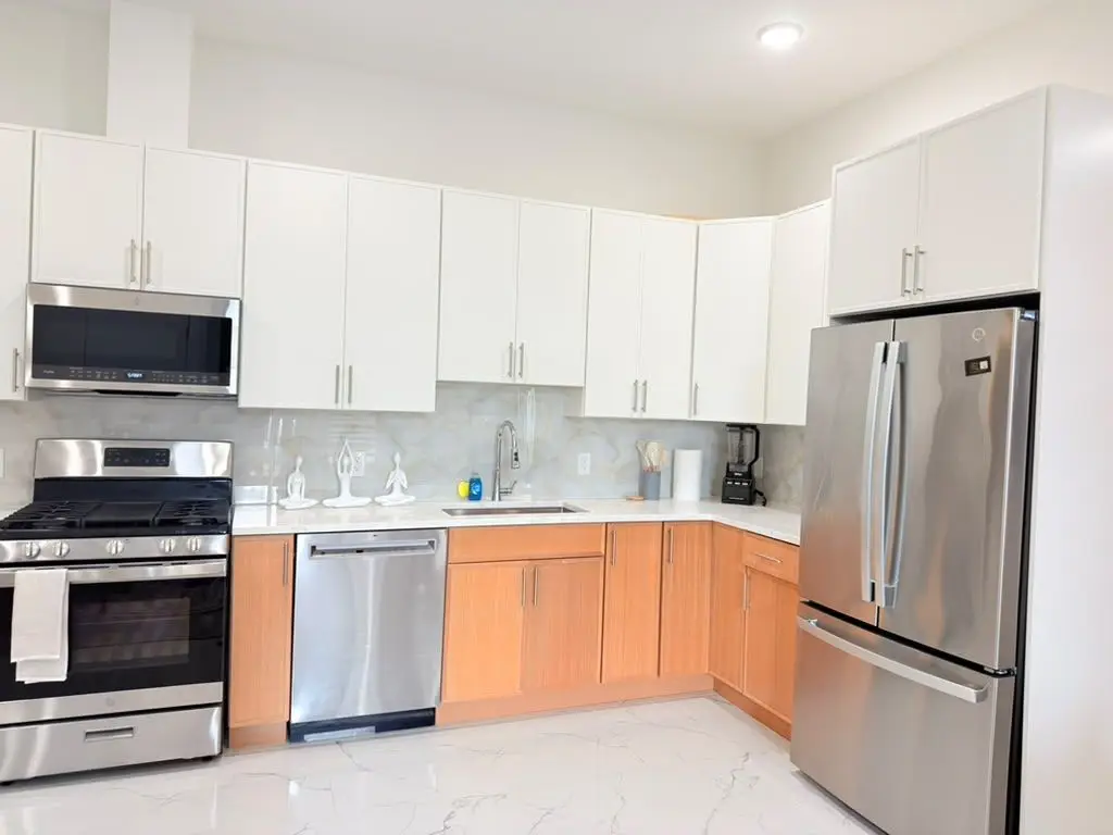 Kitchen with stainless refrigerator, range and dishwasher, Residence 411