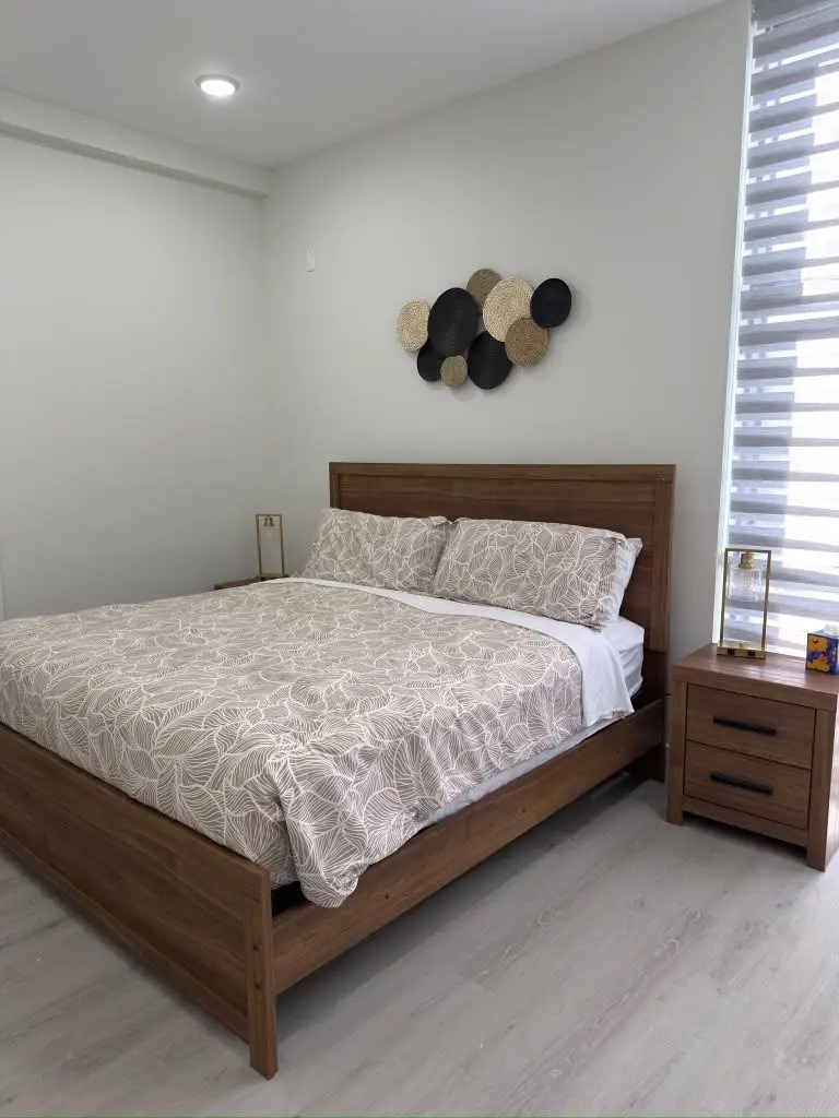 Bedroom with wood-frame bed, Residence 411