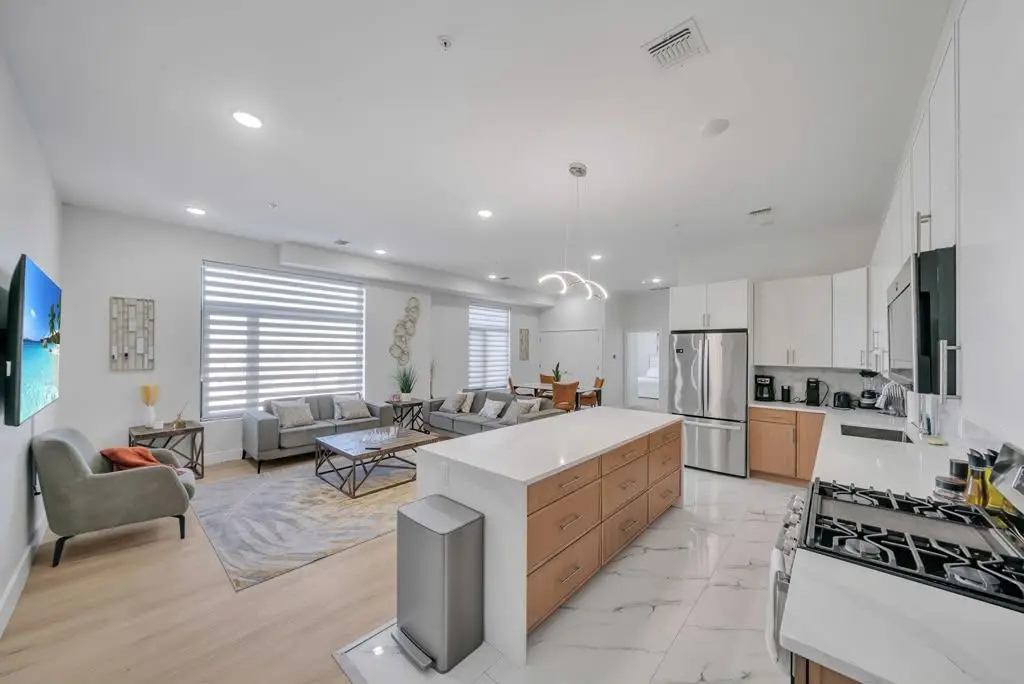 Wide view of living area and kitchen island