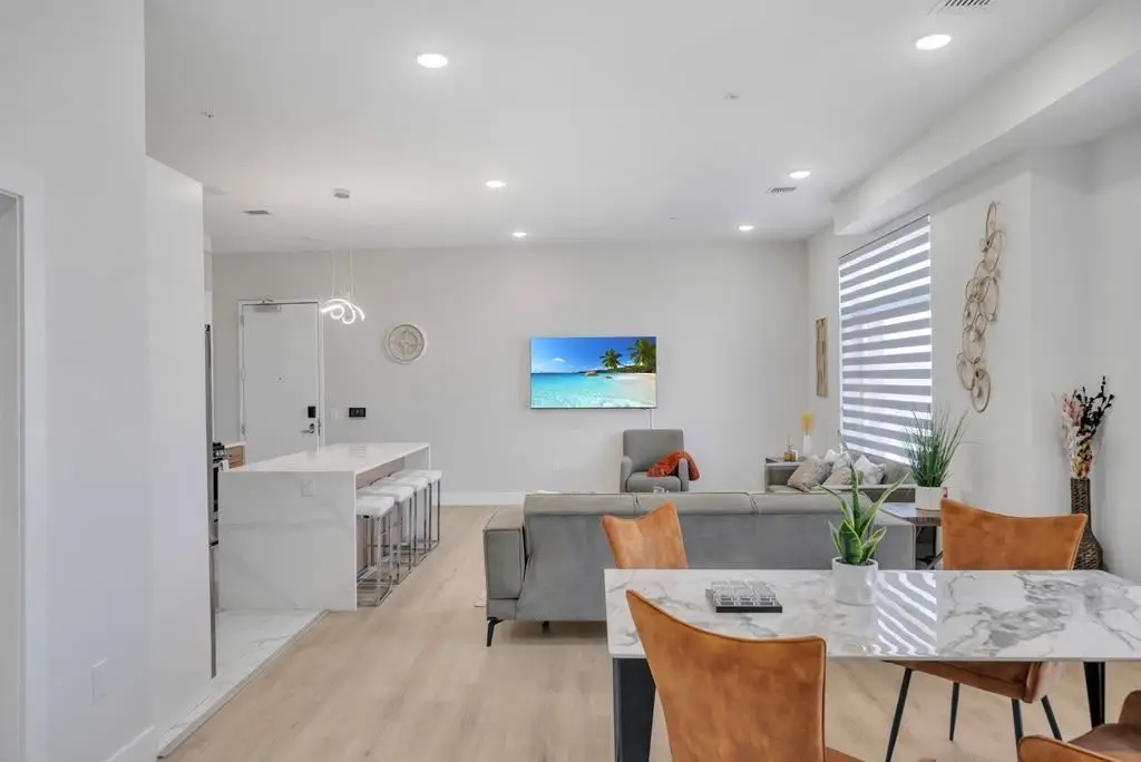Open living and dining area with kitchen beyond, Residence 416