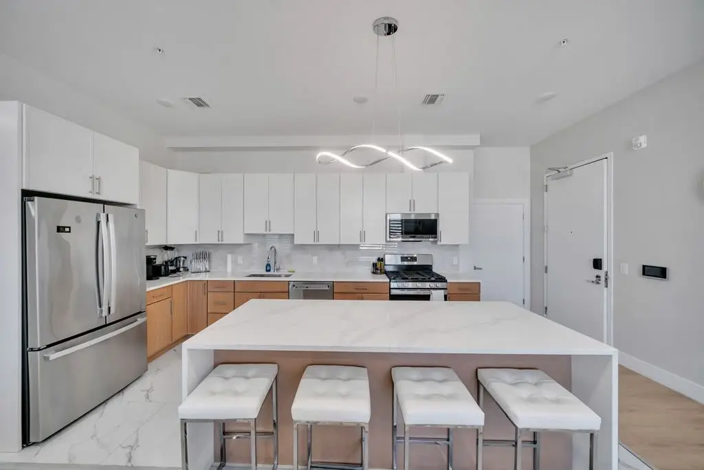Kitchen island with bar stools and stainless refrigerator, Residence 416