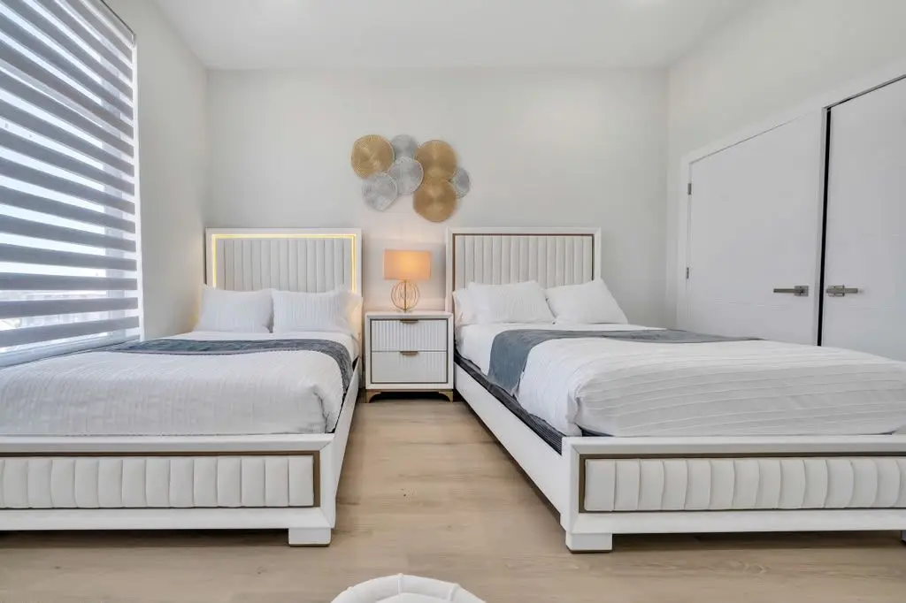 Bedroom with two beds and closet doors, Residence 416