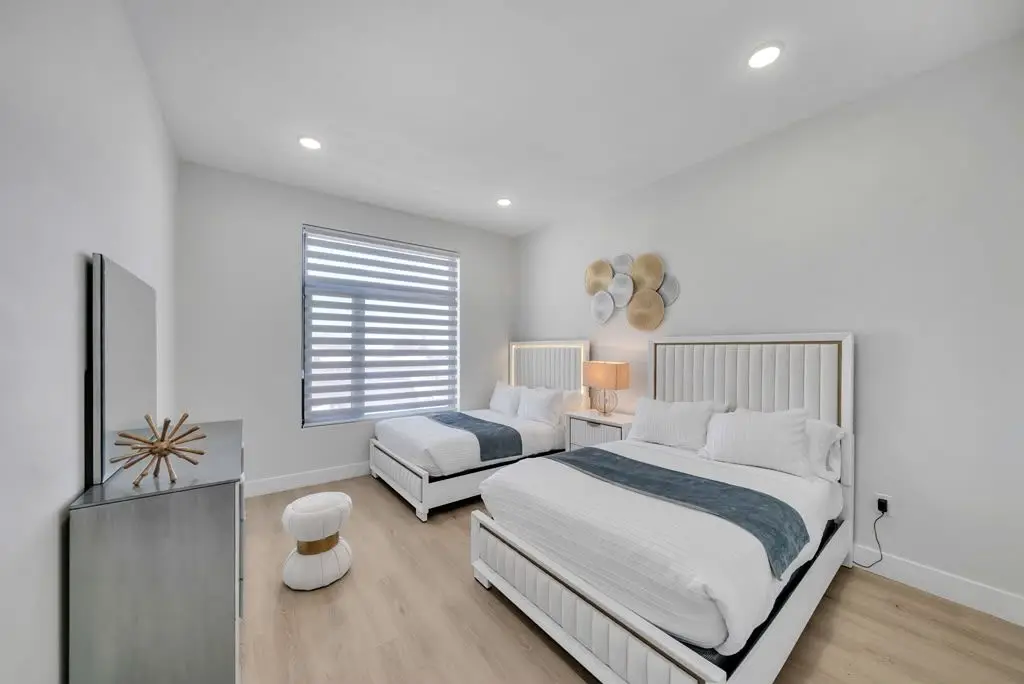 Bedroom with two beds and window, Residence 416