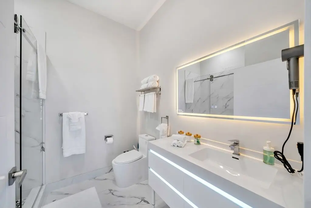 Bathroom with LED-lit mirror and vanity, Residence 416