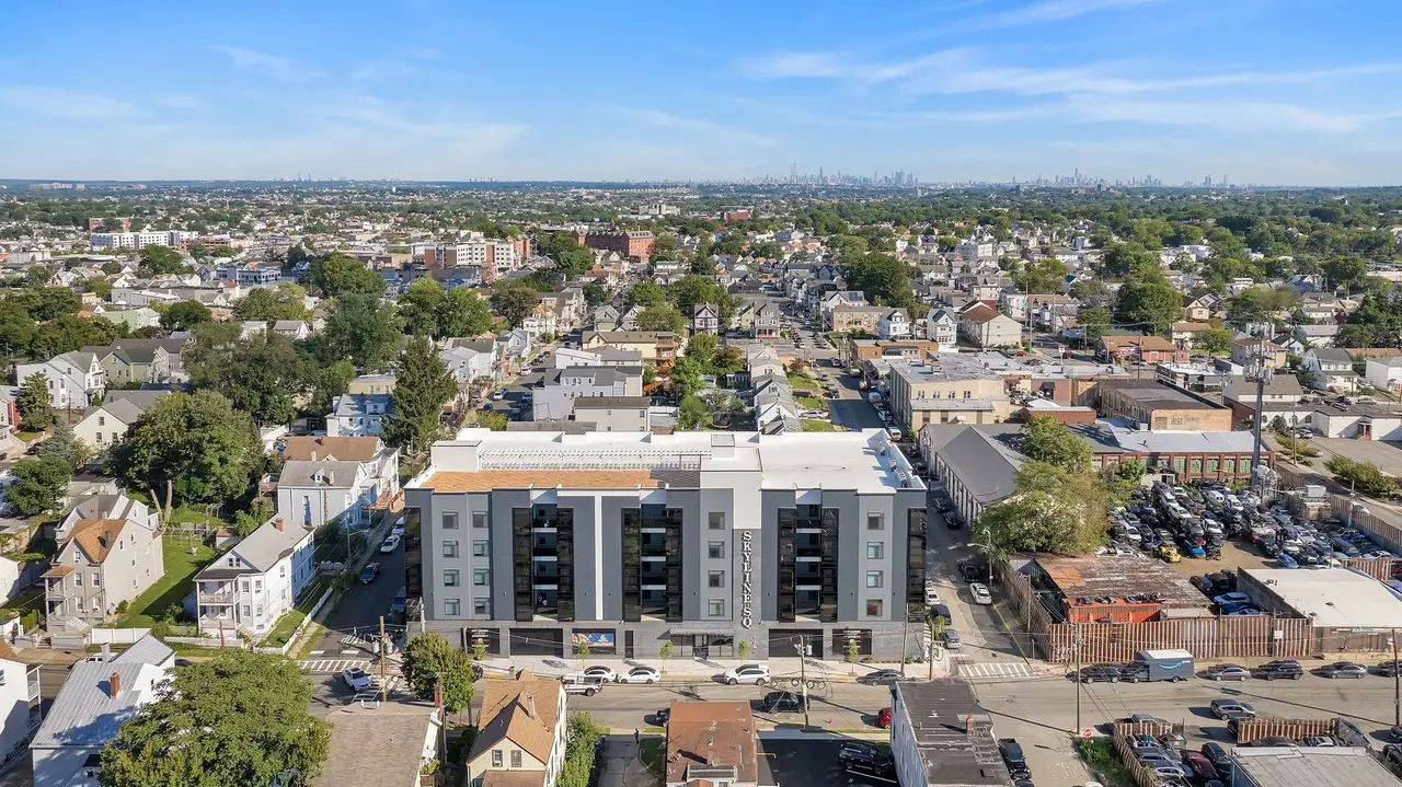 Aerial view of the building within the surrounding neighborhood