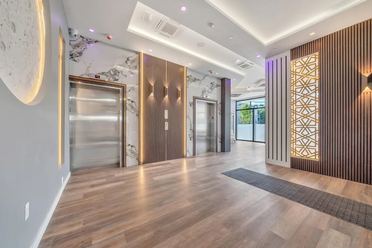 Lobby with elevators and wood-slat feature wall